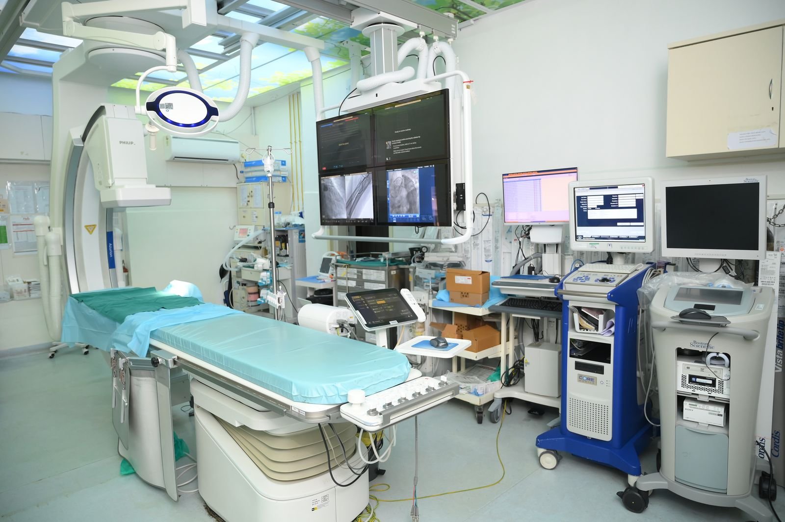 Cardiac catheterisation lab with imaging and monitoring equipment